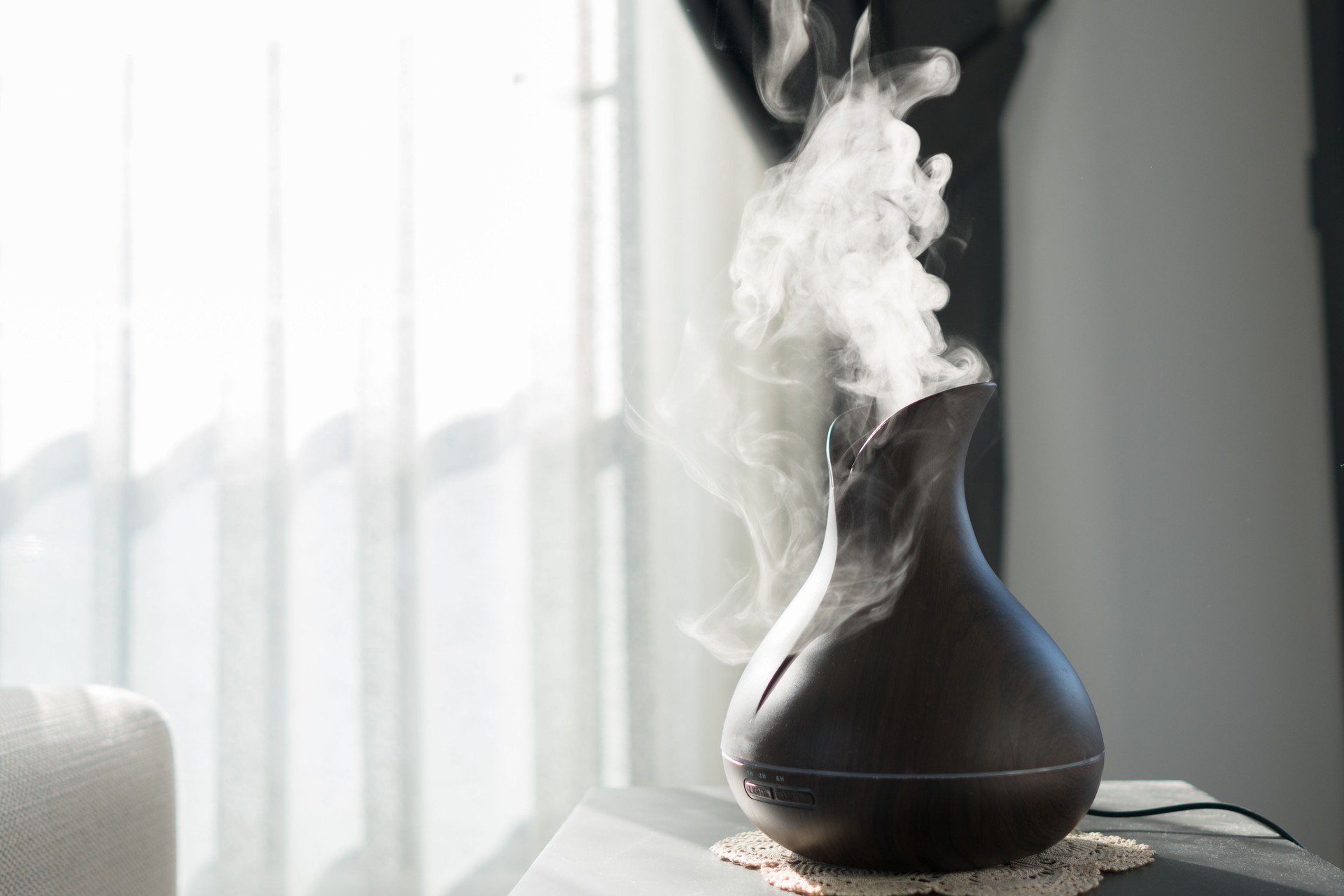 Aroma oil diffuser lamp on the table .